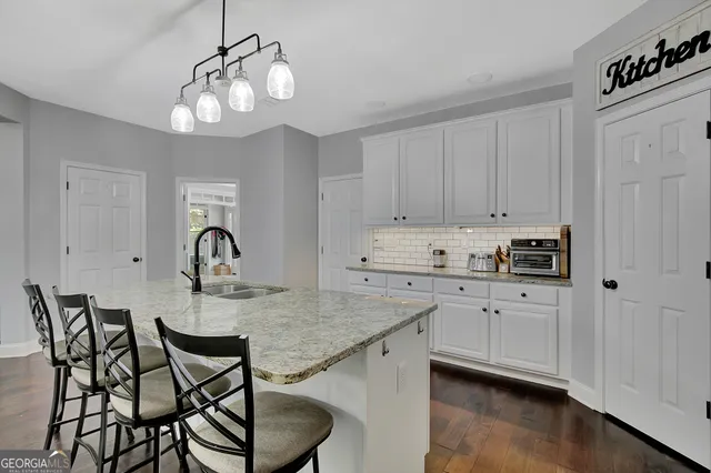 a kitchen with center island table and chairs