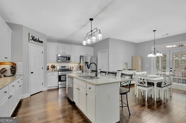 a view of a dining room with furniture kitchen and chandelier