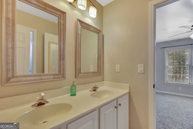 a view of a livingroom with a window and a ceiling fan