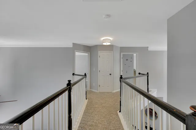 a spacious bedroom with a bed and a chandelier