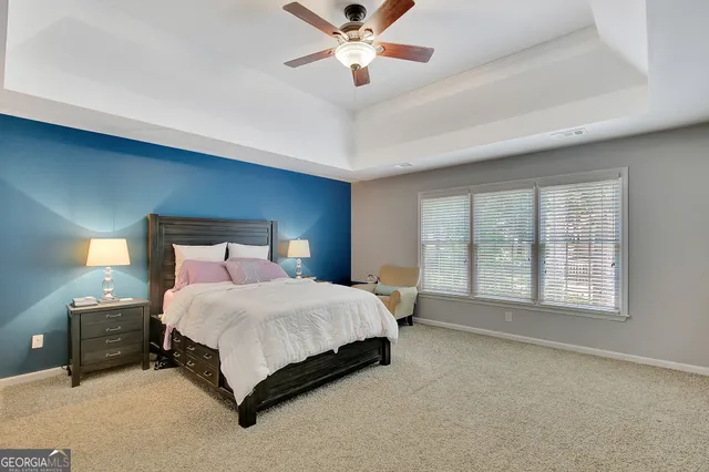 a spacious bathroom with a sink and mirror with shower