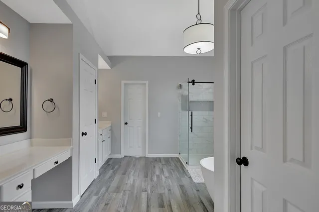 a front view of a house with a yard and potted plants