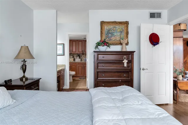 a bedroom with a bed and cabinets