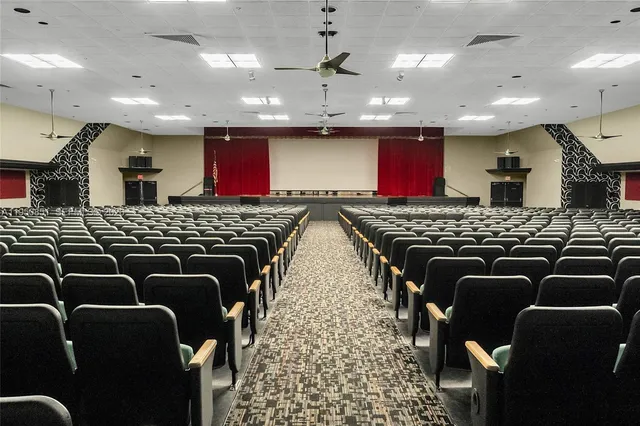 a bathroom with stainless steel appliances granite countertop a stove a sink and a refrigerator