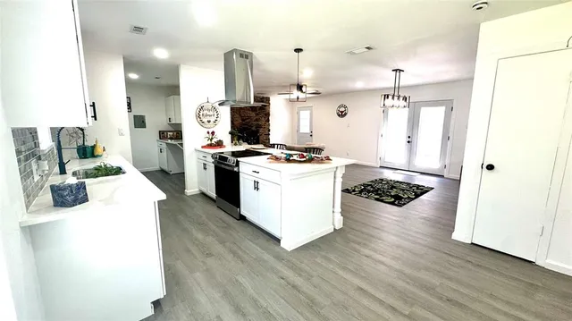 a kitchen with a stove a refrigerator and a oven