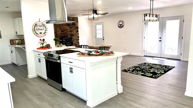 a kitchen with a stove a sink and a refrigerator