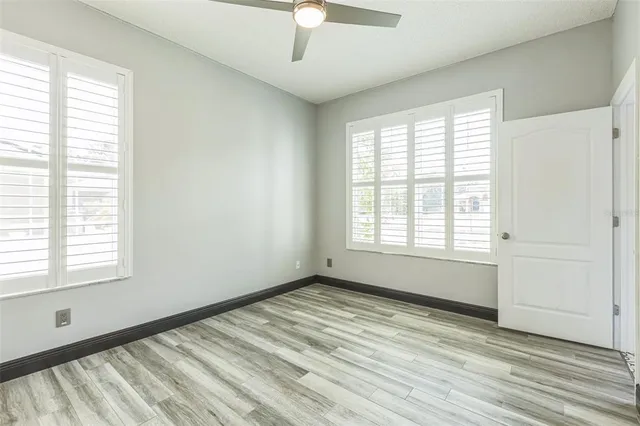 a view of a hallway with wooden floor and stairs