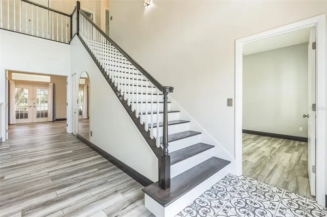 a view of a hallway with wooden floor and staircase