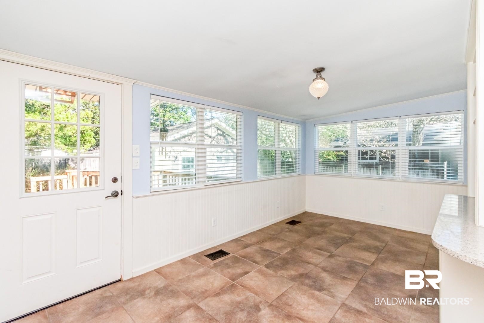 10 South Hathaway Road Mobile, AL 36608 - Photo 17 of 46 Unfurnished sunroom with lofted ceiling and plenty of natural light