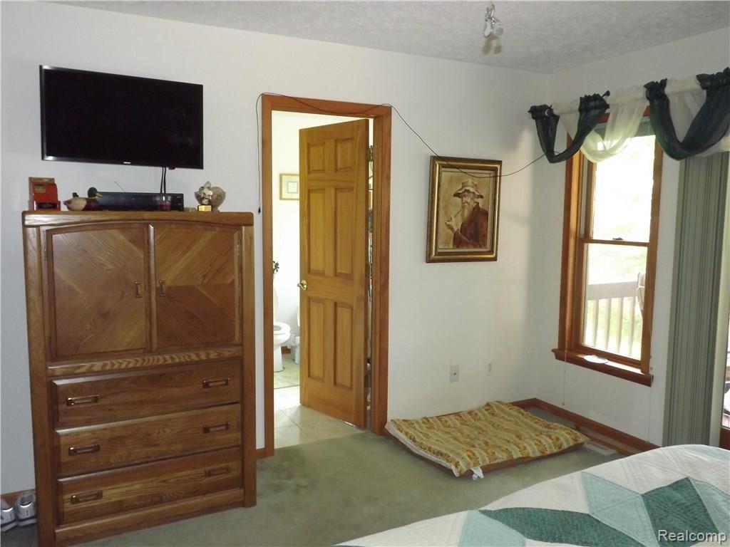 2825 Burden Road Stockbridge, MI 49285 - Photo 28 of 62 Master bedroom with en suite