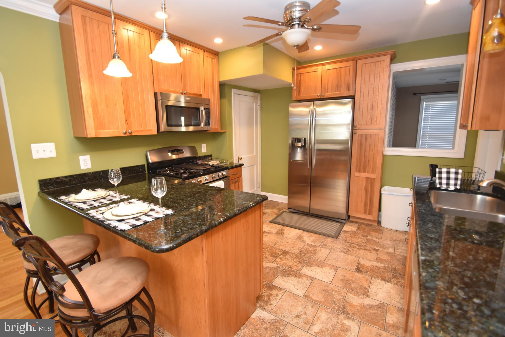 22 Tanglewood Road Baltimore, MD 21228 - Photo 9 of 25 Granite countertops/pendant lights show off kit.