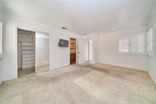 a view of empty room with closet and stairs