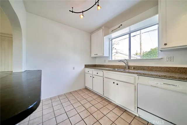 a kitchen with a sink cabinets and window