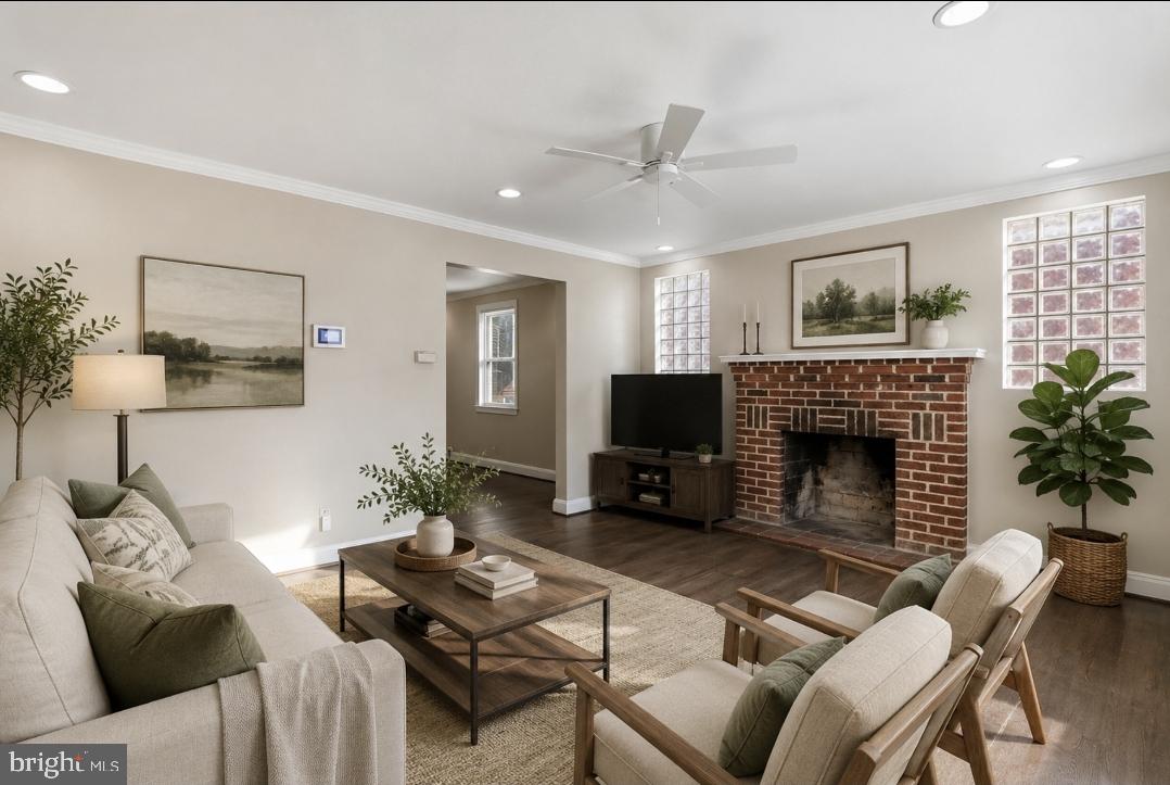 5102 Plymouth Road Baltimore, MD 21214 - Photo 30 of 32 a living room with furniture a fireplace and a flat screen tv