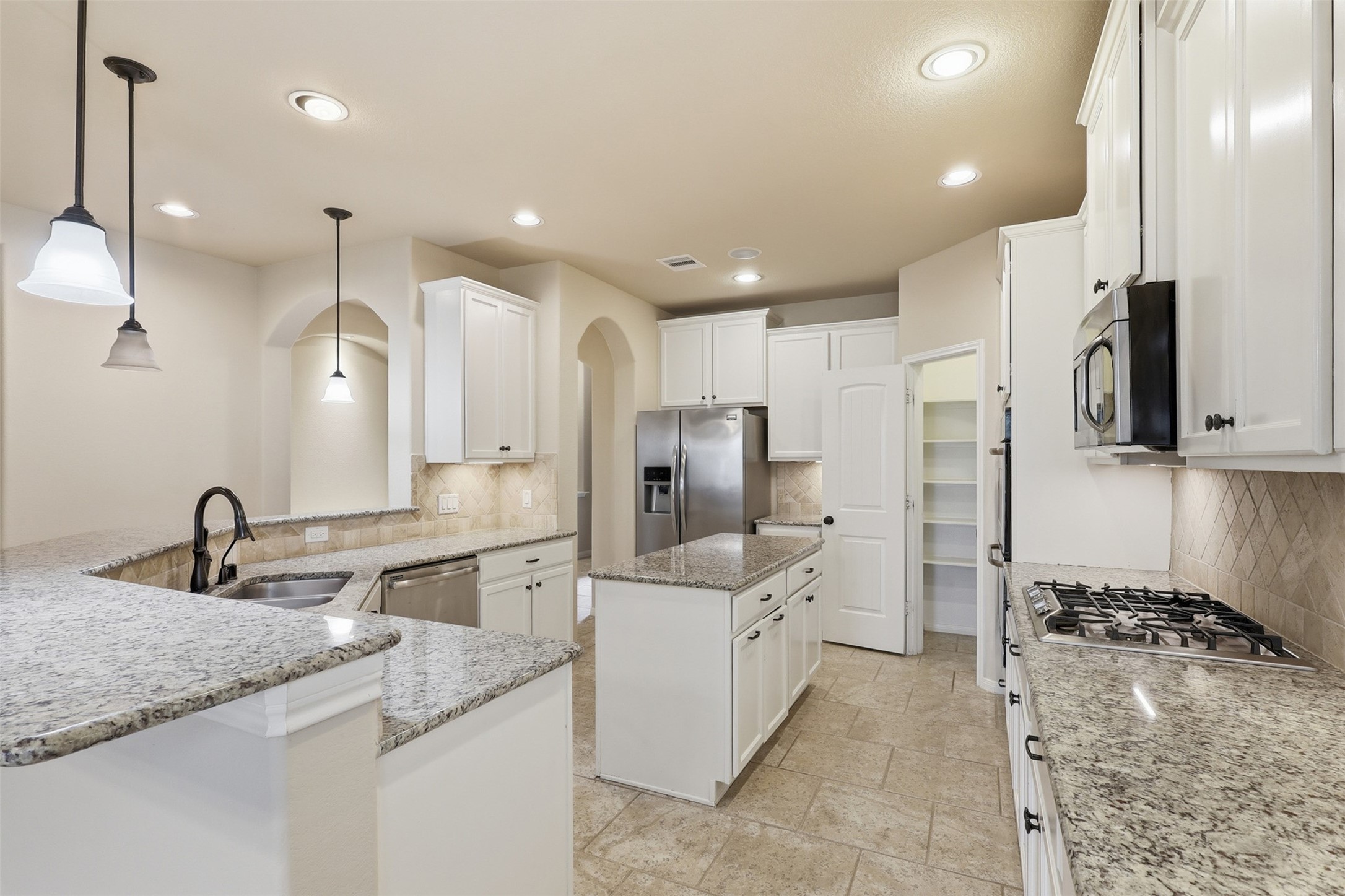 22943 Dale River Road Tomball, TX 77375 - Photo 9 of 29 a kitchen with a sink stove and refrigerator
