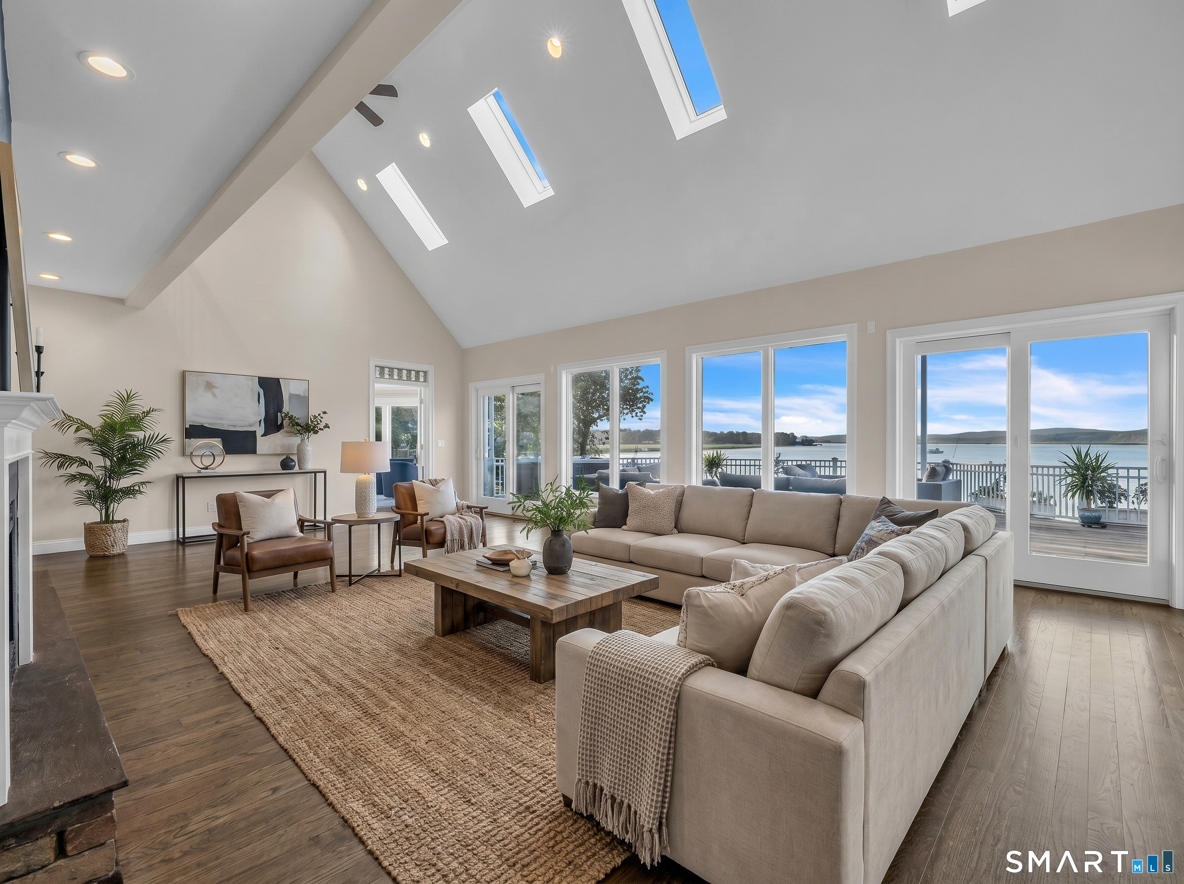 12 Rocky Point Road Old Saybrook, CT 06475 - Photo 10 of 28 a living room with furniture wooden floor and a large window