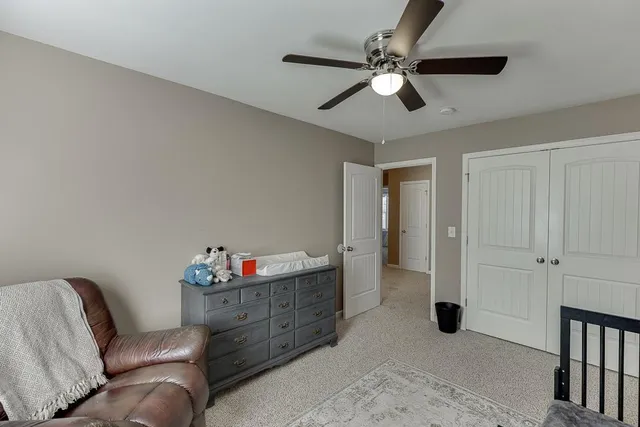 a living room with furniture and a ceiling fan