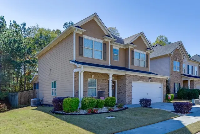 a front view of a house with a yard and garage