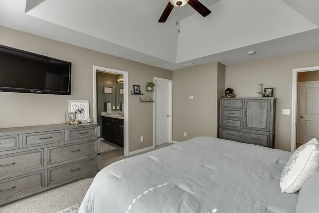 a bedroom with a large bed and a flat screen tv