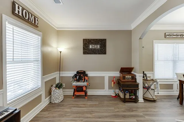 a view of a workspace with furniture and a window