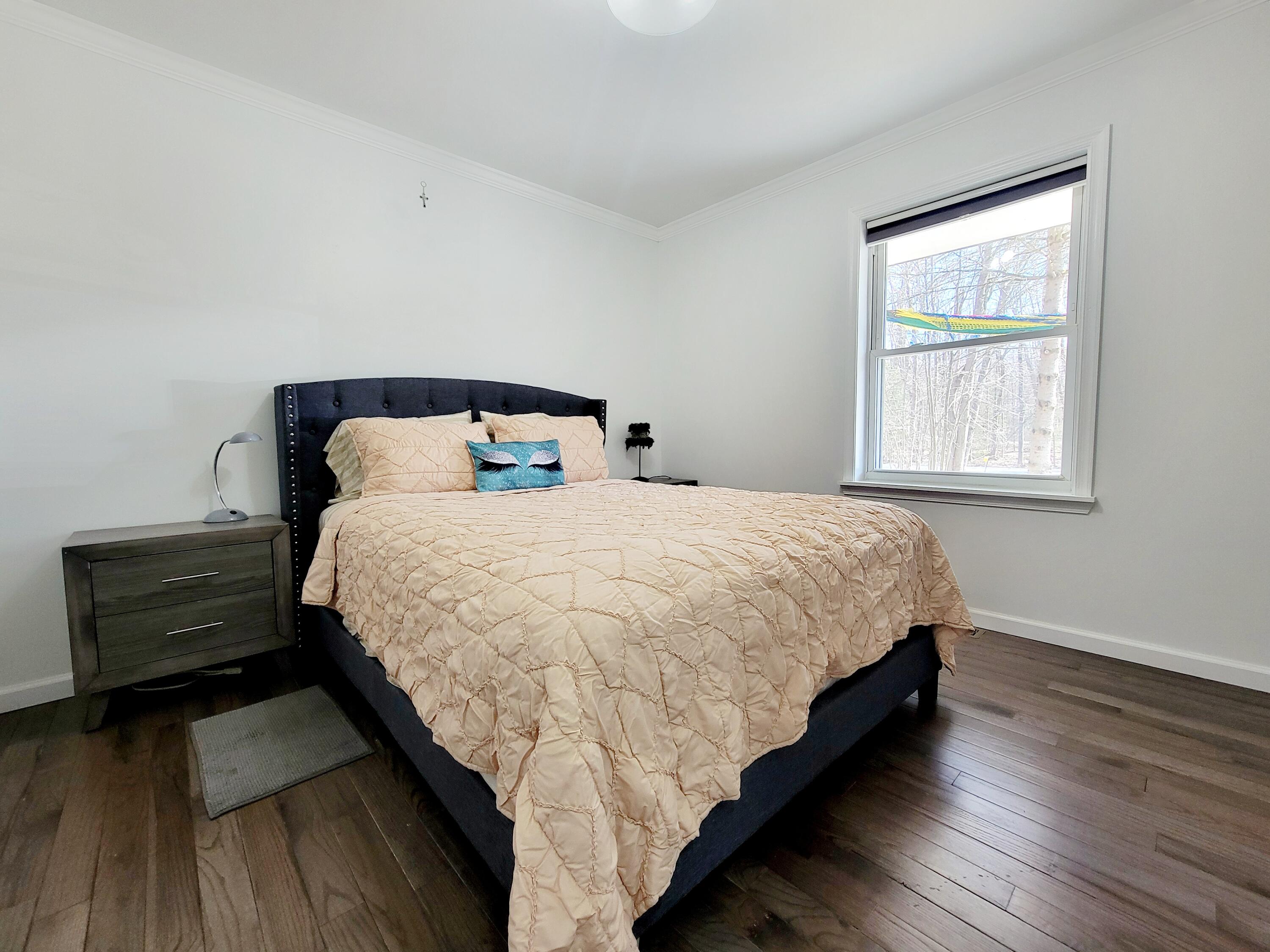 6395 Cherokee Trail Tobyhanna, PA 18466 - Photo 29 of 48 a bed sitting in a bedroom next to a window