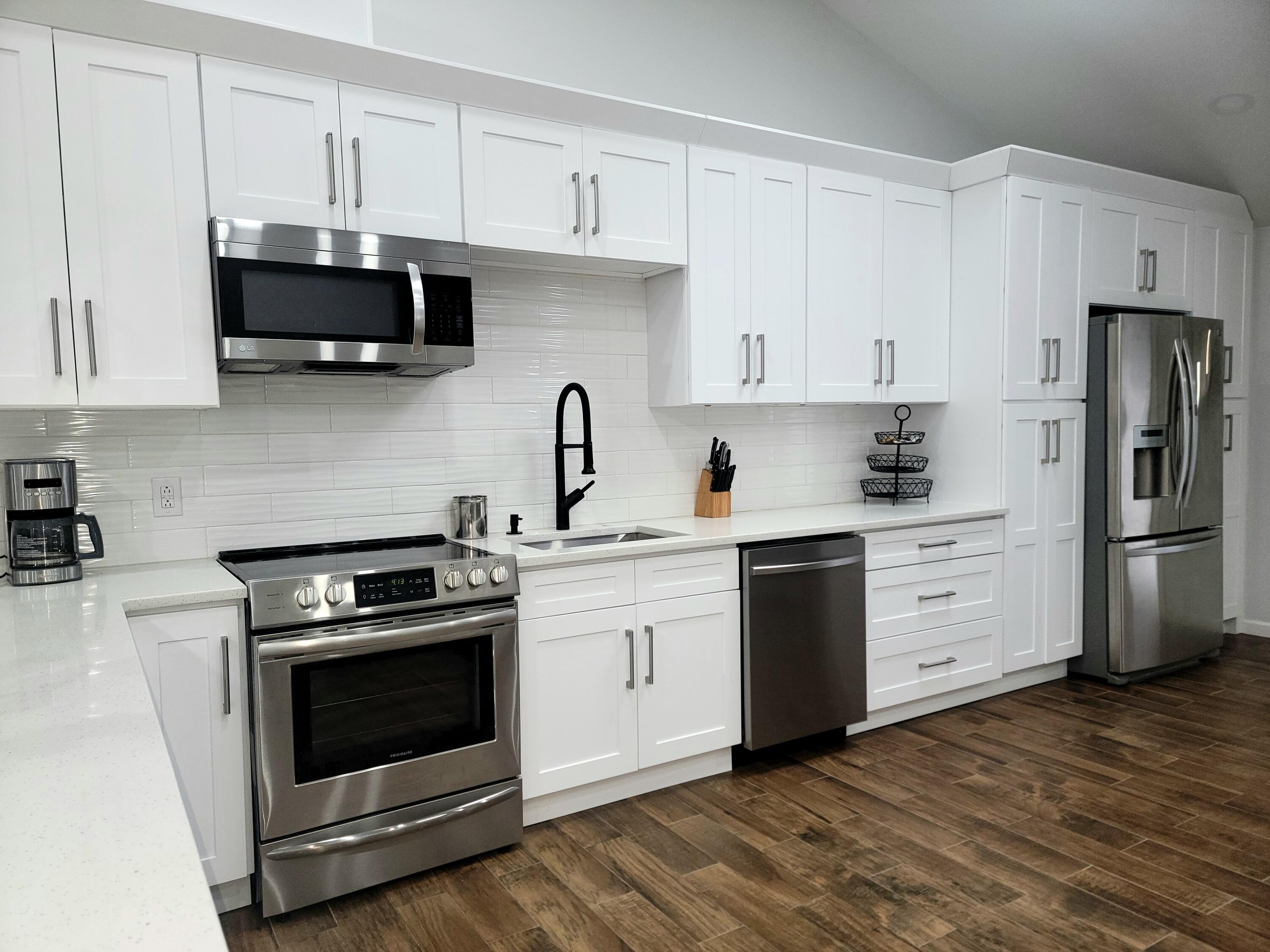 6395 Cherokee Trail Tobyhanna, PA 18466 - Photo 3 of 48 a kitchen with white cabinets and stainless steel appliances