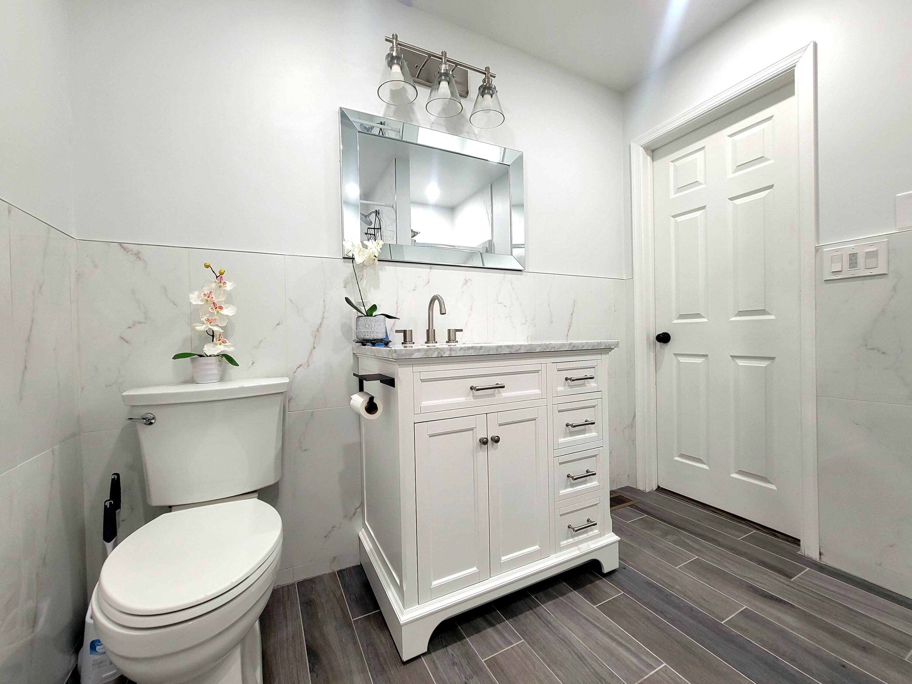 6395 Cherokee Trail Tobyhanna, PA 18466 - Photo 32 of 48 a bathroom with a toilet a sink and mirror