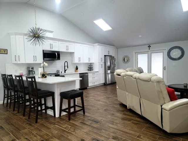 a kitchen with stainless steel appliances white cabinets and a refrigerator
