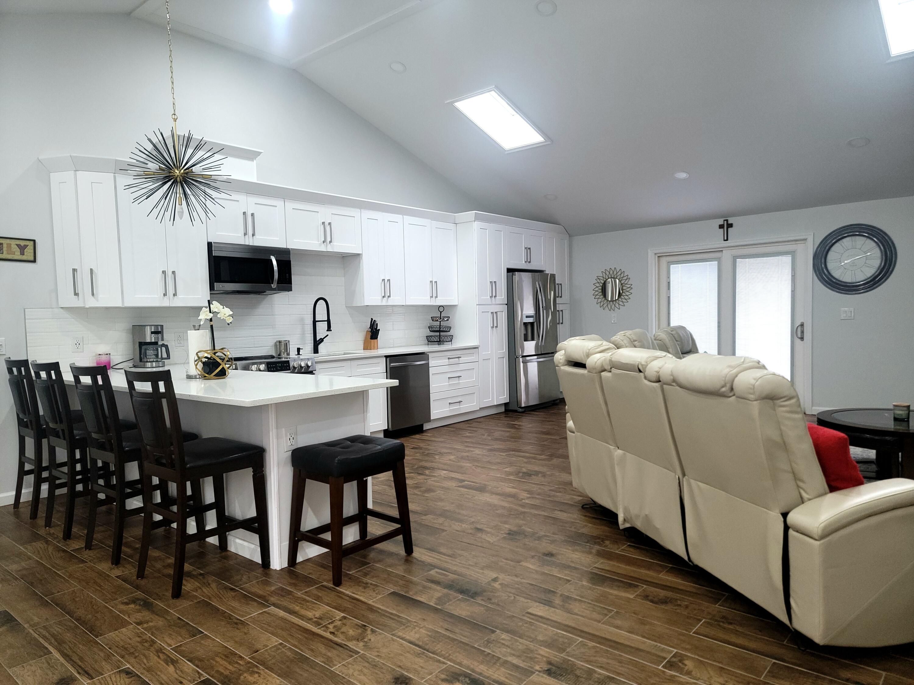 6395 Cherokee Trail Tobyhanna, PA 18466 - Photo 7 of 48 a living room with stainless steel appliances kitchen island granite countertop furniture and a wooden floor