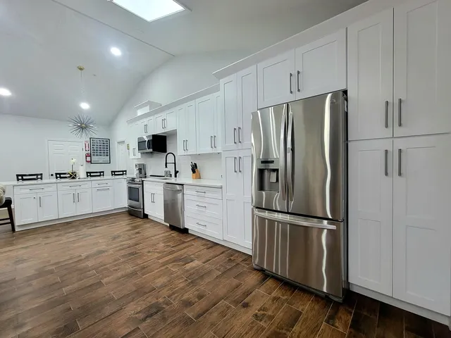 a living room with furniture and kitchen view