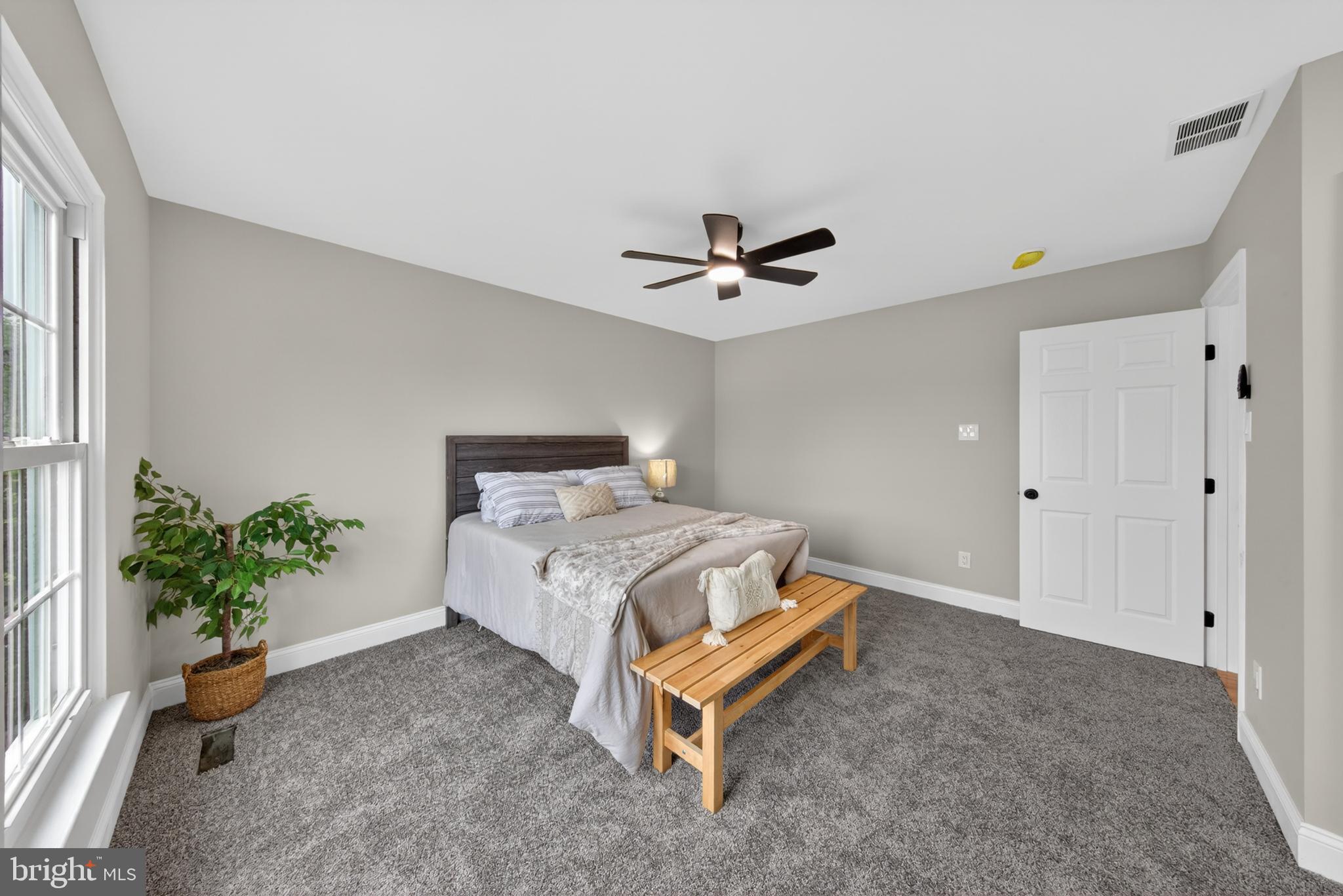 20 Baywatch Road New Castle, DE 19720 - Photo 43 of 76 a bedroom with a bed and a potted plant