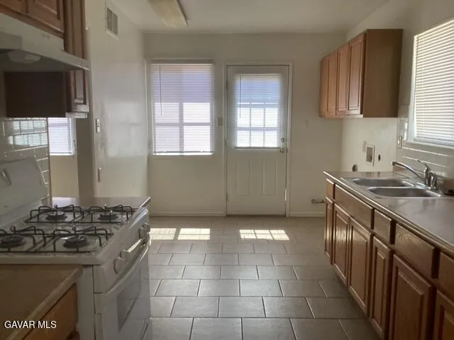 a kitchen with a sink stove and cabinets