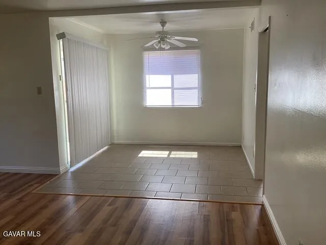 a view of a hallway with a window and a chandelier