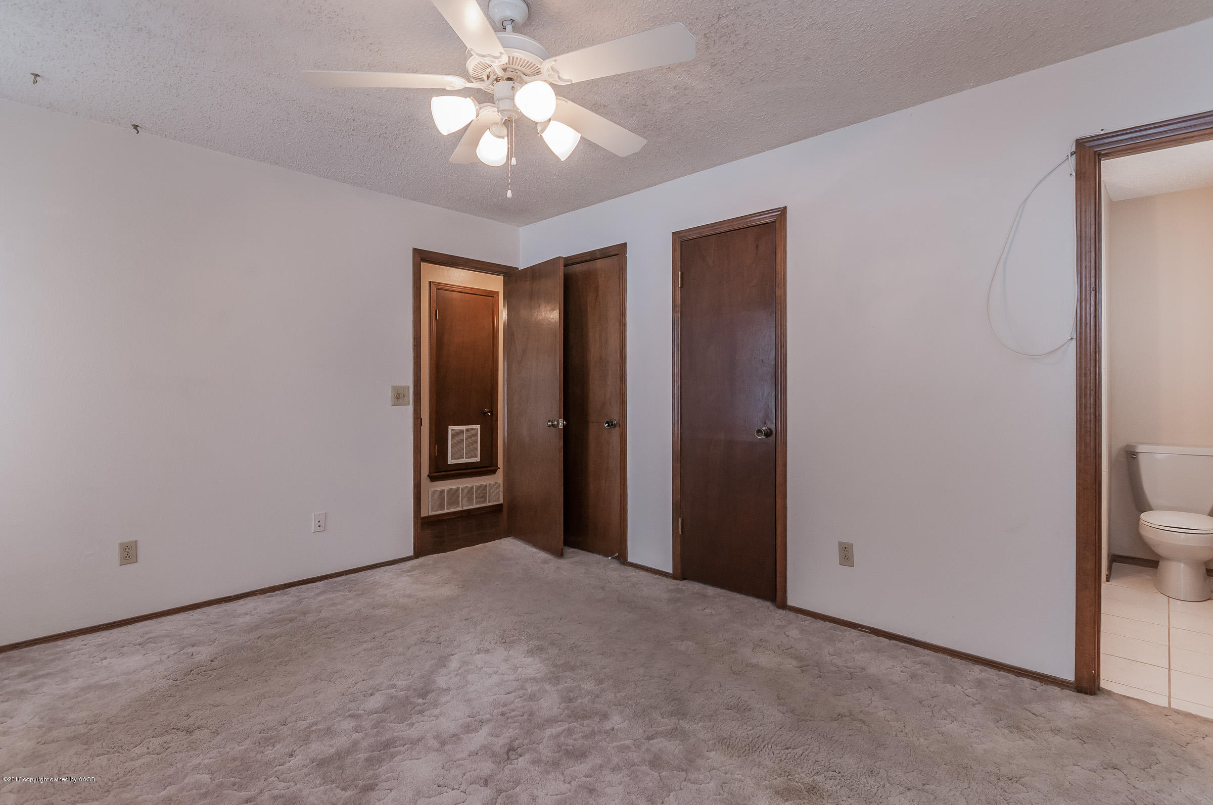 5312 Wheeler Lane Amarillo, TX 79110 - Photo 11 of 20 an empty room with a ceiling fan and a bathroom