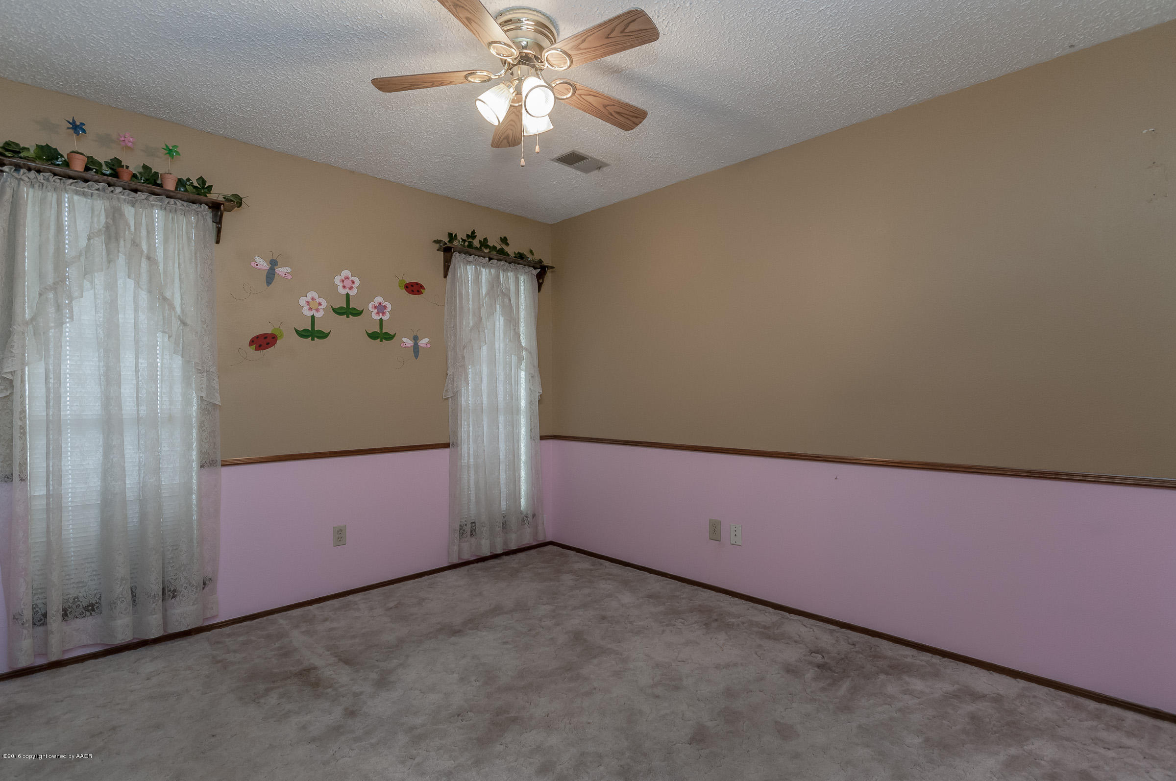 5312 Wheeler Lane Amarillo, TX 79110 - Photo 15 of 20 an empty room with a chandelier fan and glass door