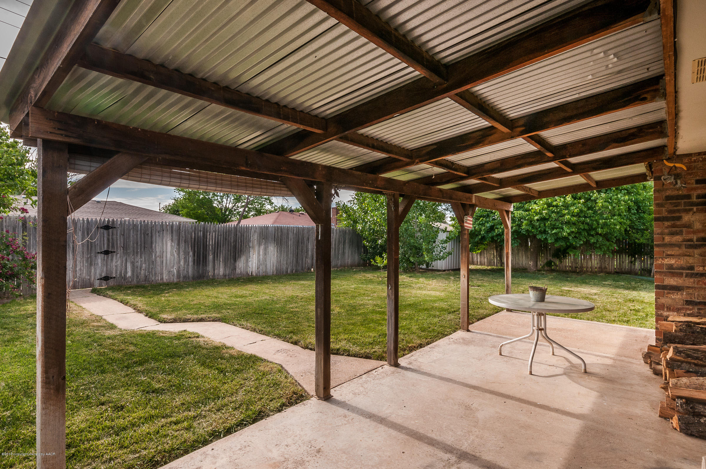 5312 Wheeler Lane Amarillo, TX 79110 - Photo 18 of 20 a view of a backyard with wooden floor and roof