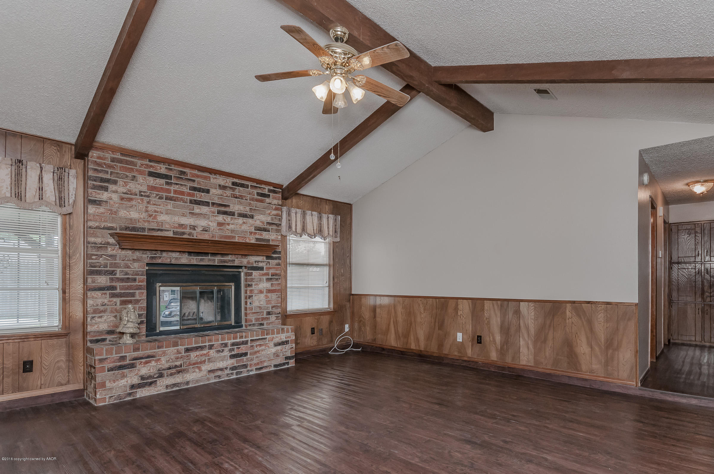 5312 Wheeler Lane Amarillo, TX 79110 - Photo 3 of 20 a view of an empty room with wooden floor fireplace and a window