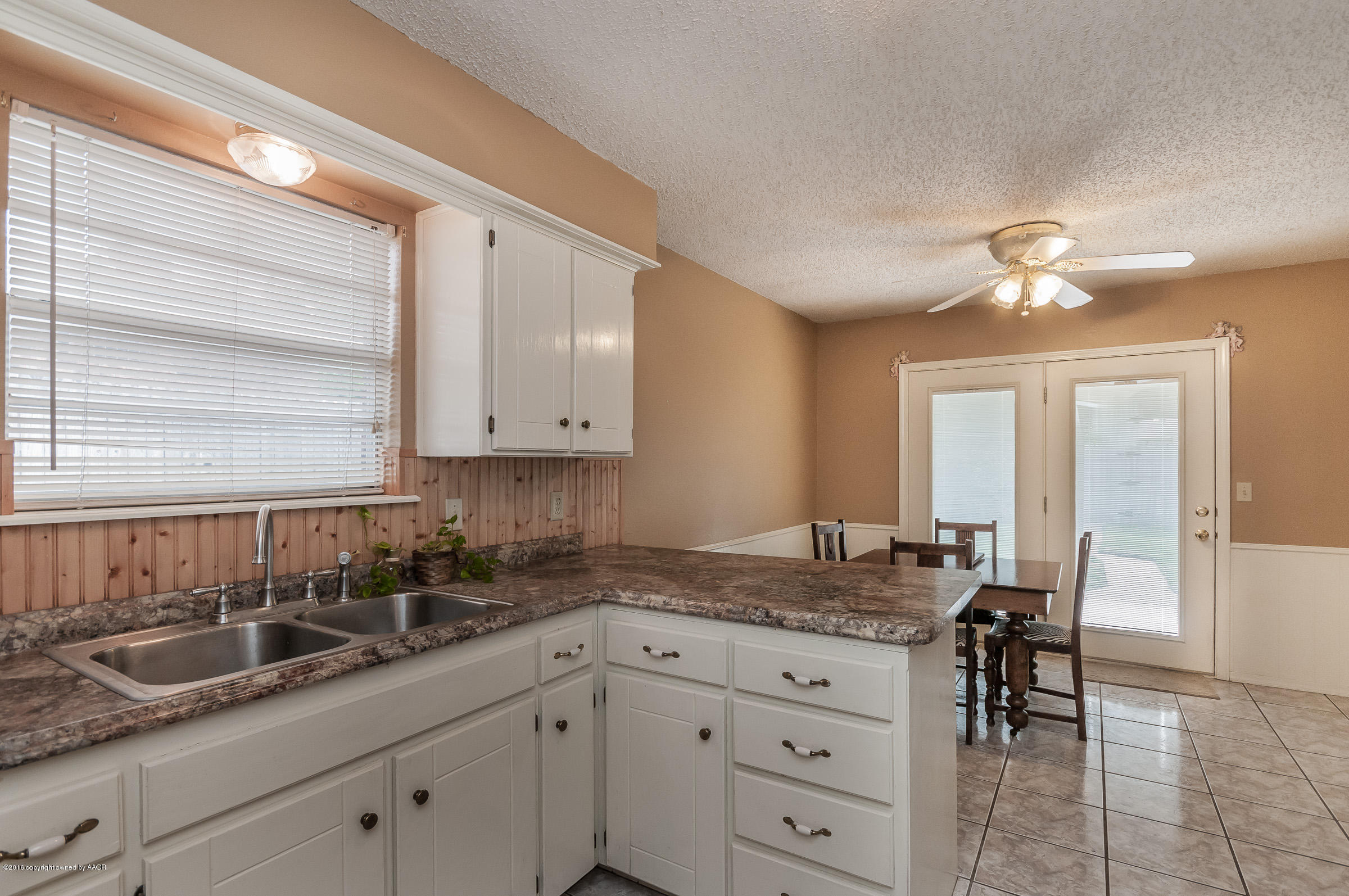 5312 Wheeler Lane Amarillo, TX 79110 - Photo 7 of 20 a kitchen with granite countertop a sink a stove and cabinets