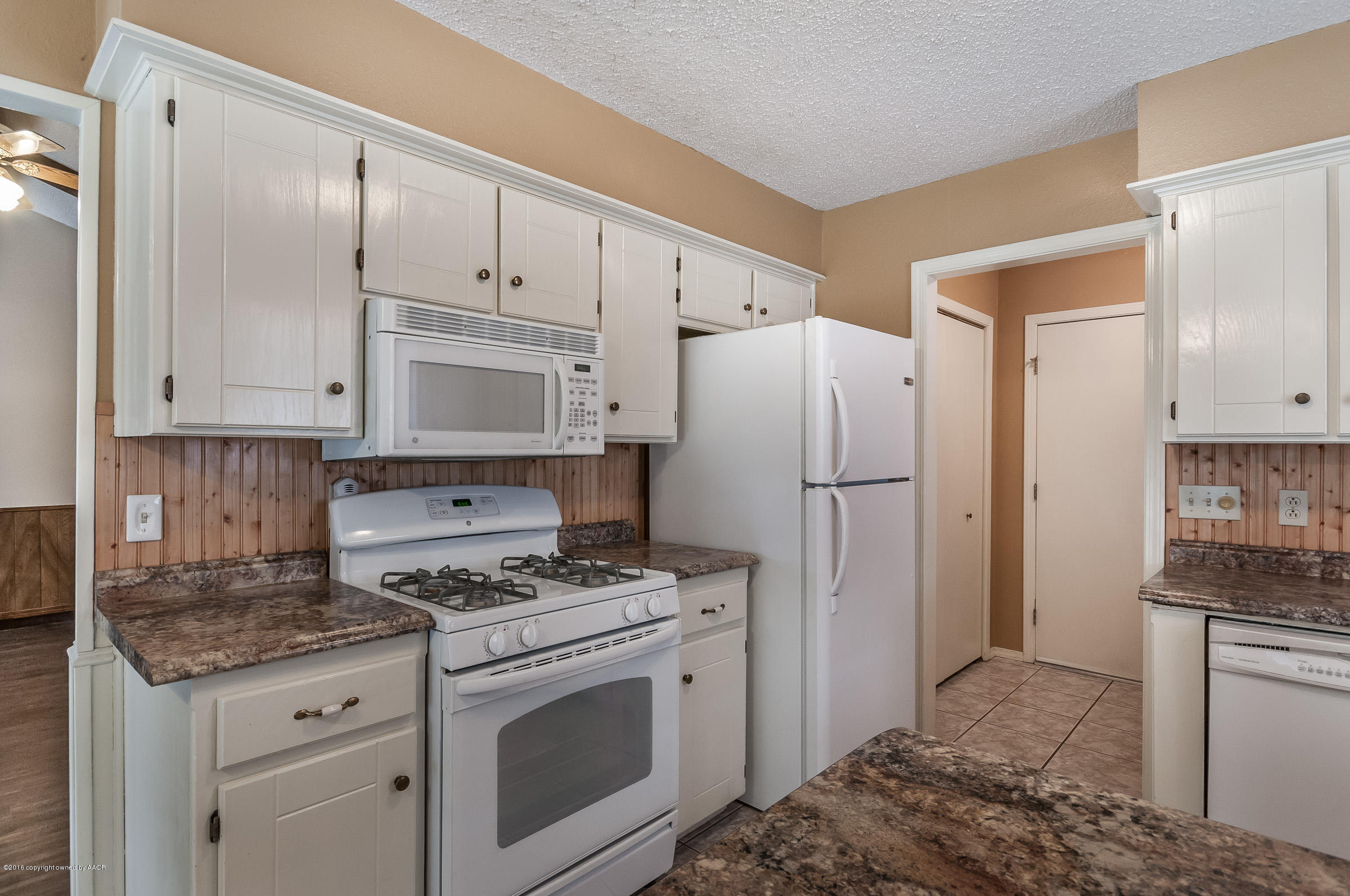 5312 Wheeler Lane Amarillo, TX 79110 - Photo 8 of 20 a kitchen with white cabinets and white appliances