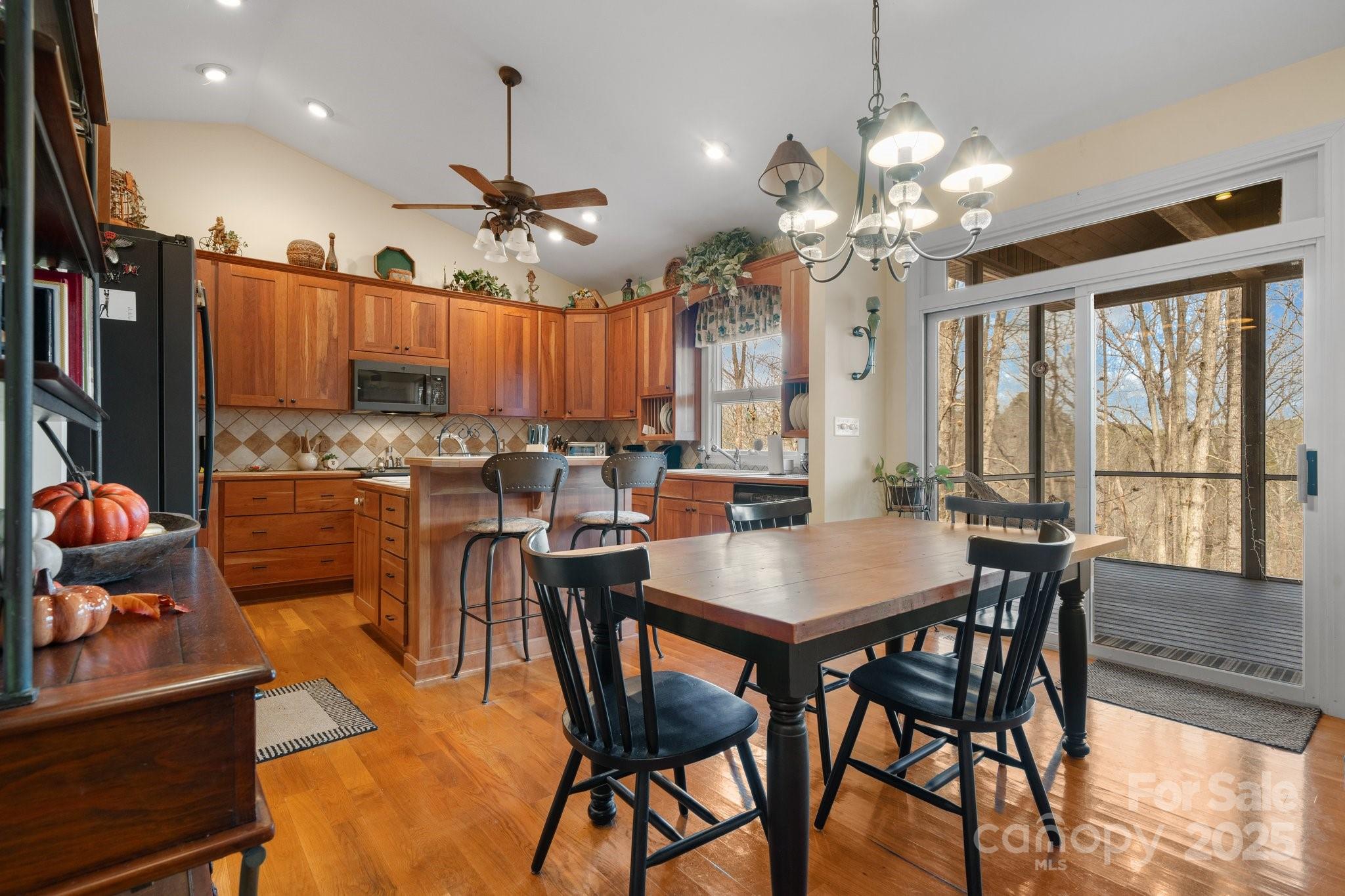 4530 Meandering Way Conover, NC 28613 - Photo 13 of 48 a view of a dining room with furniture a chandelier and wooden floor