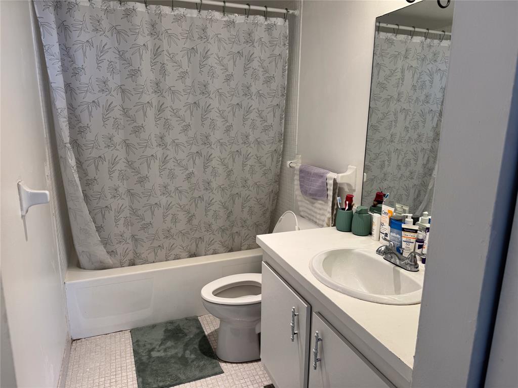 4174 Inverrary Drive, Unit 905 Lauderhill, FL 33319 - Photo 11 of 23 a bathroom with a sink toilet and shower