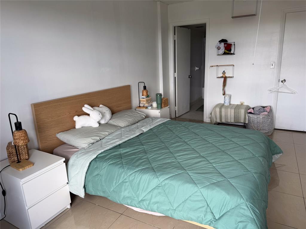 4174 Inverrary Drive, Unit 905 Lauderhill, FL 33319 - Photo 2 of 23 a bedroom with a bed and a chandelier