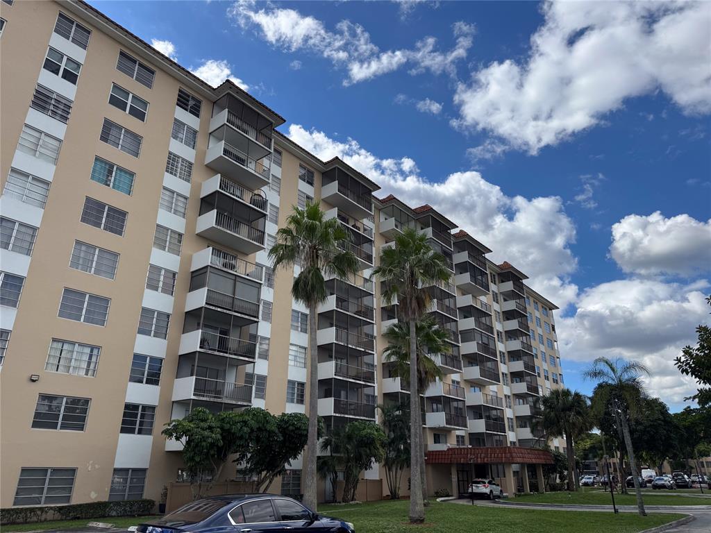 4174 Inverrary Drive, Unit 905 Lauderhill, FL 33319 - Photo 21 of 23 a view of a tall building with a yard