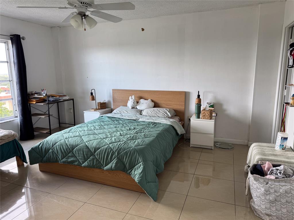 4174 Inverrary Drive, Unit 905 Lauderhill, FL 33319 - Photo 3 of 23 a bedroom with a bed and wooden floor