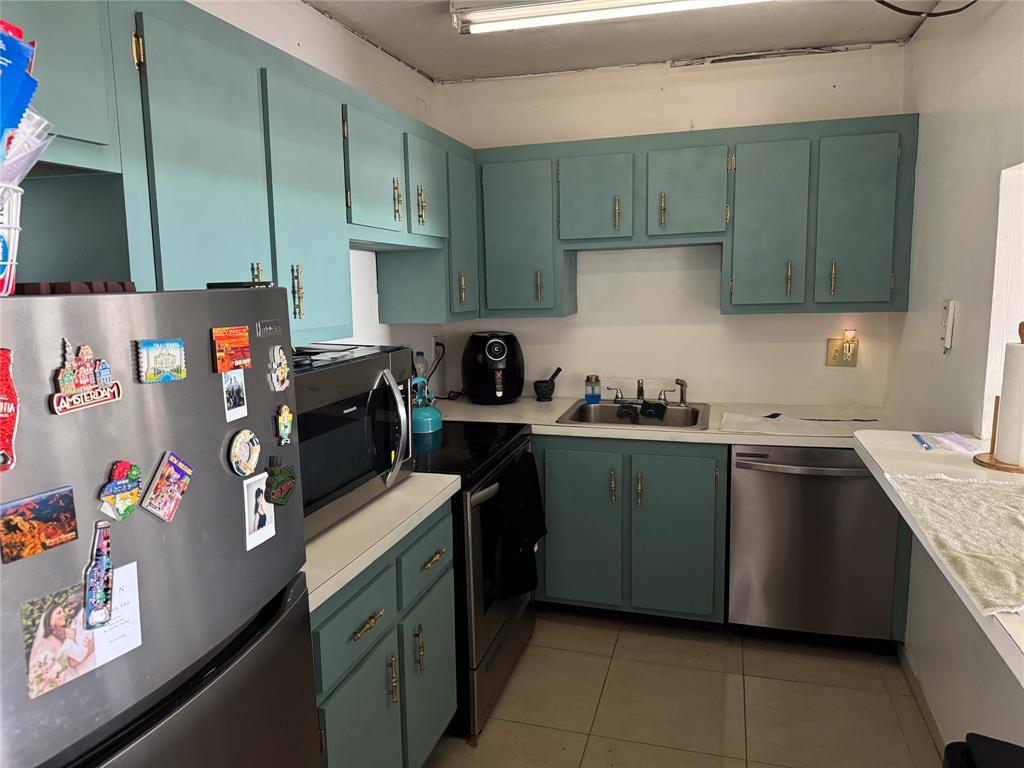 4174 Inverrary Drive, Unit 905 Lauderhill, FL 33319 - Photo 4 of 23 a kitchen with stainless steel appliances granite countertop a sink stove and refrigerator