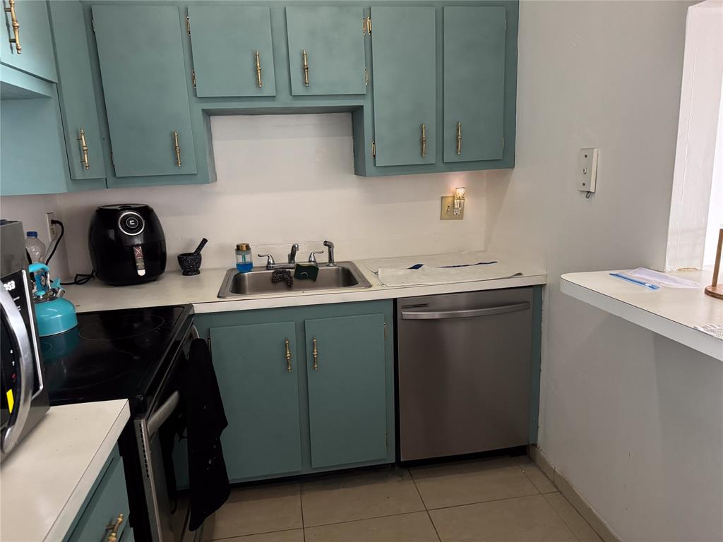 4174 Inverrary Drive, Unit 905 Lauderhill, FL 33319 - Photo 6 of 23 a kitchen with a sink cabinets and wooden floor