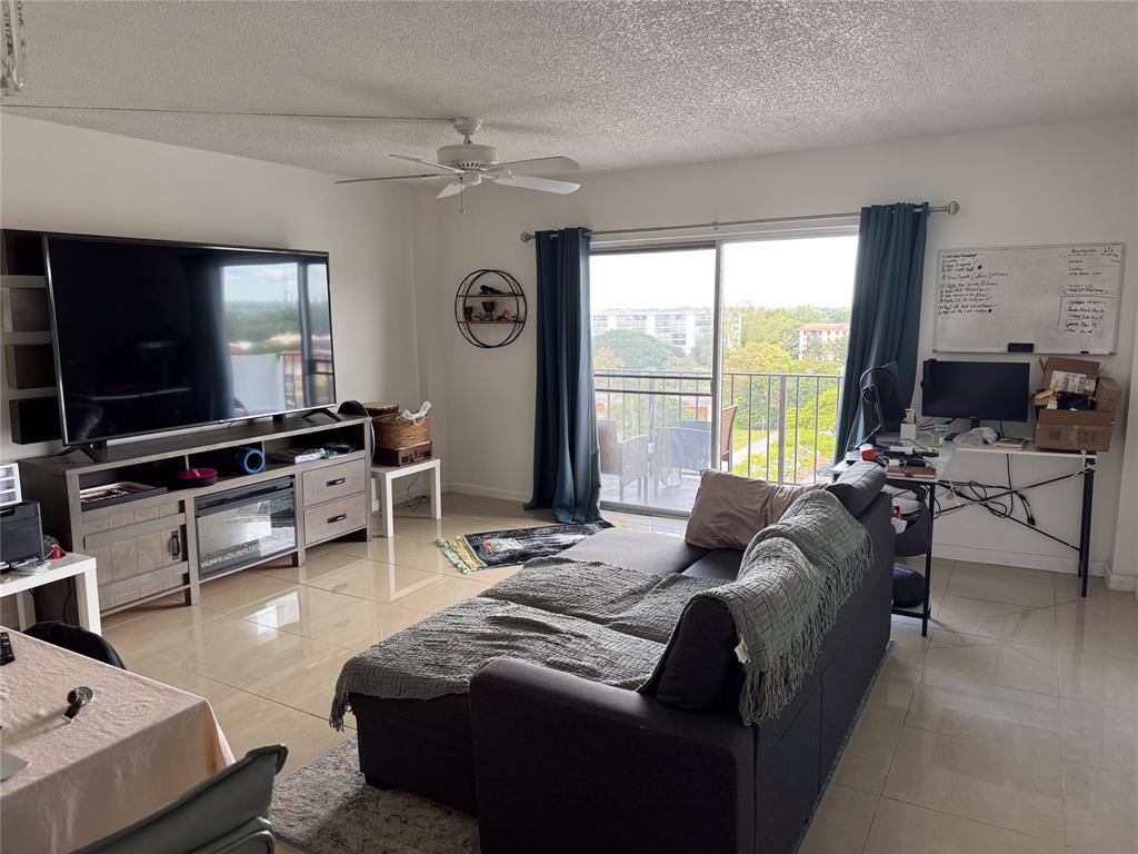4174 Inverrary Drive, Unit 905 Lauderhill, FL 33319 - Photo 8 of 23 a living room with furniture and a flat screen tv