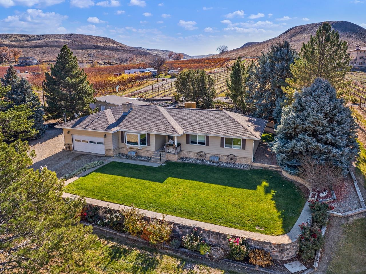 an aerial view of a house with swimming pool and a yard