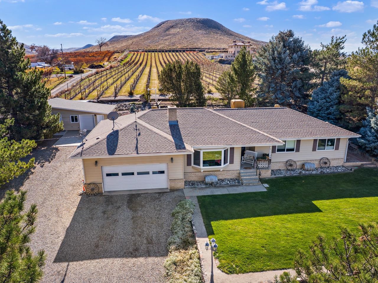 an aerial view of a house with swimming pool and a yard
