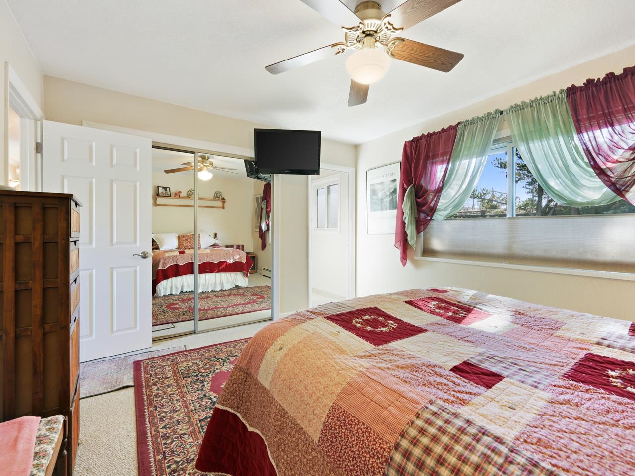 3697 F Road Palisade, CO 81526 - Photo 18 of 40 a bedroom with a bed and a chandelier